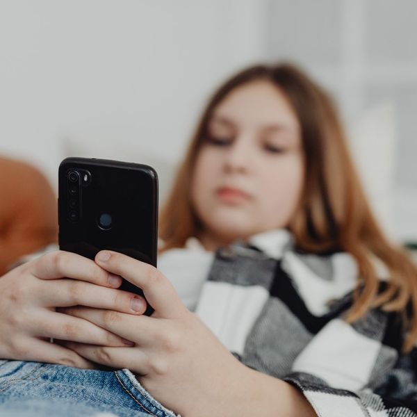 A teen girl on her phone.