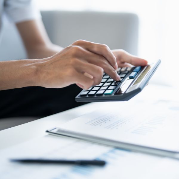 person using a calculator to do their bills person using a calculator to do their bills