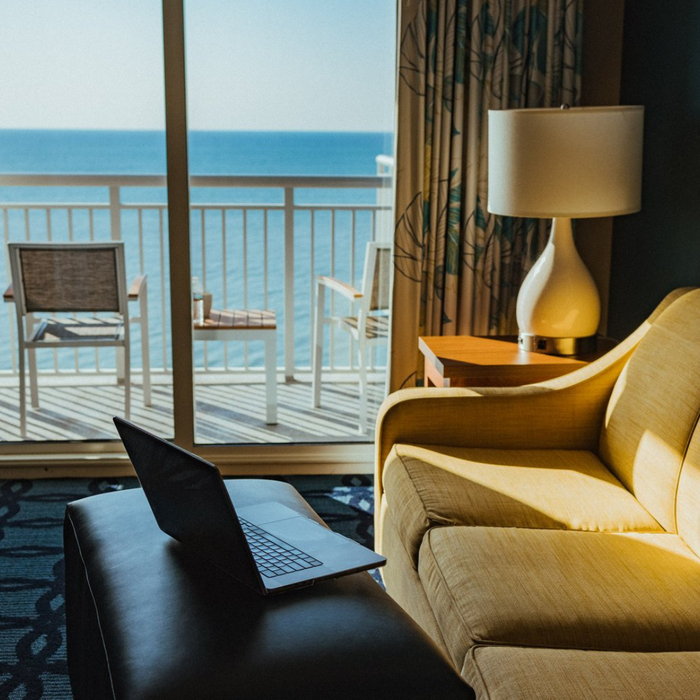 Relaxing Hotel Room Overlooking the Ocean with Workspace Setup