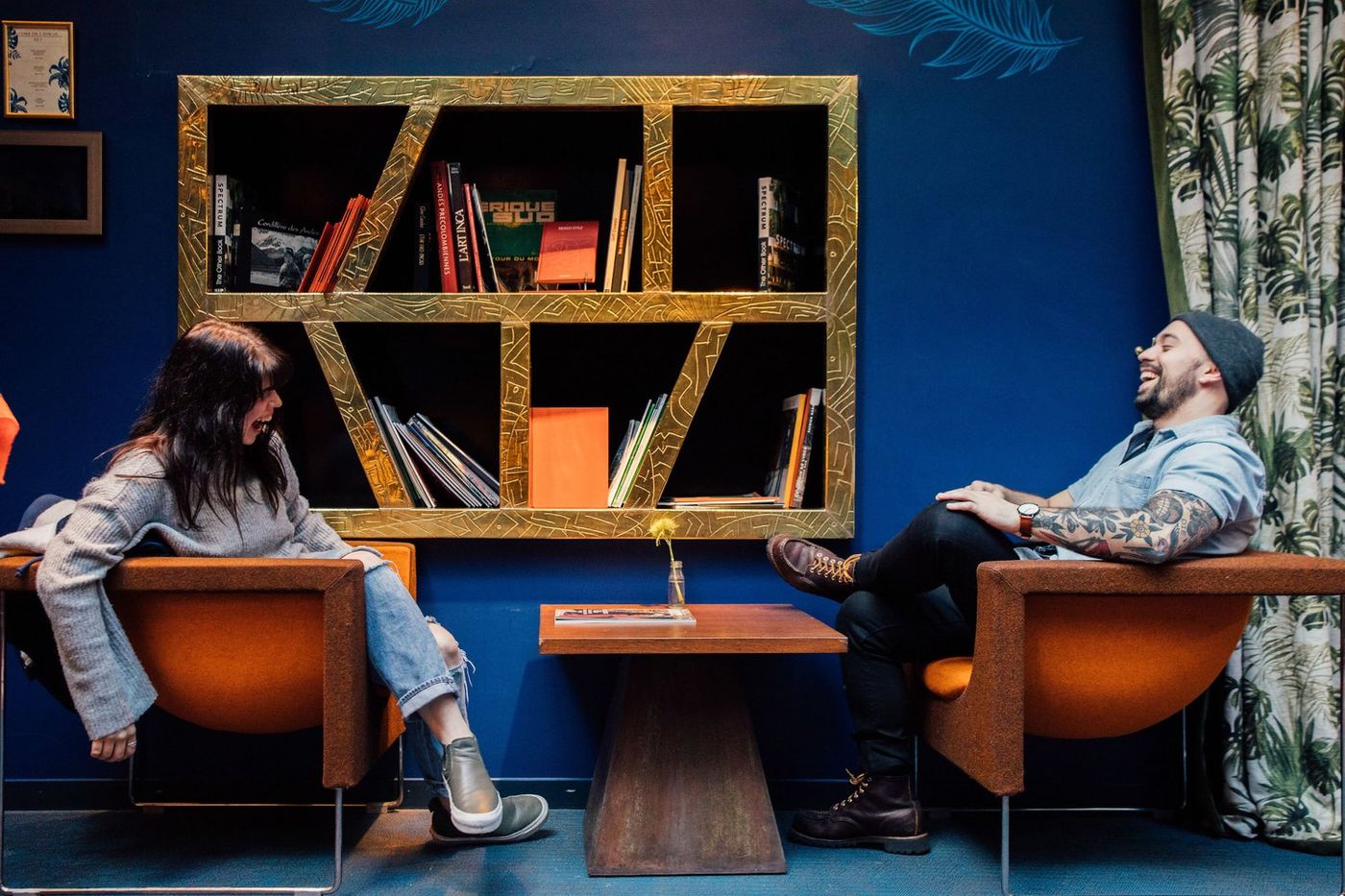 Male and female laughing in Paris hotel lounge