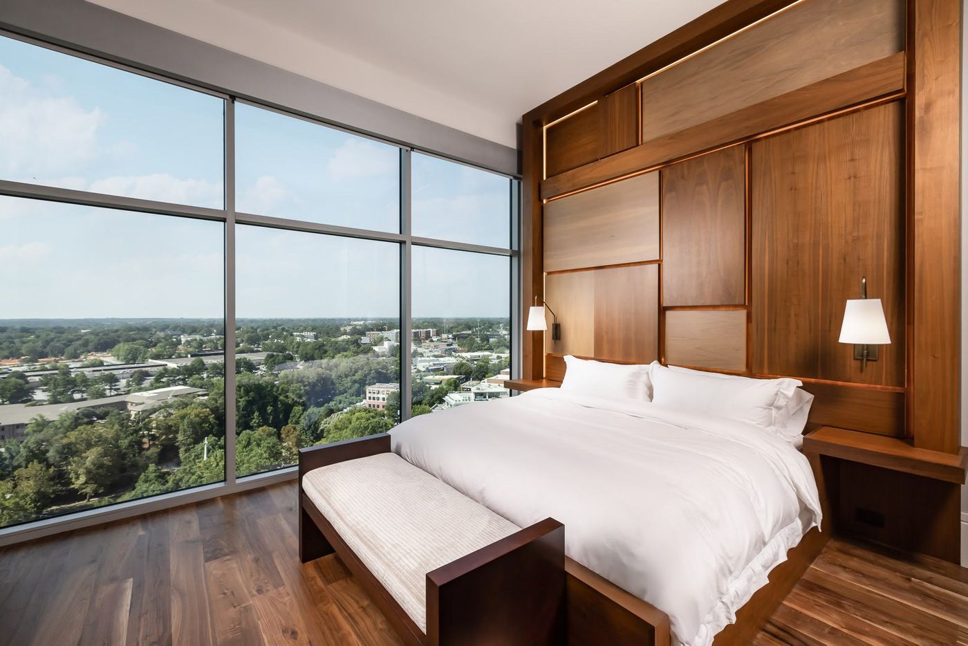 Modern Upstate Penthouse king bed with wooden accent wall