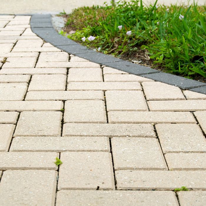 paver driveway with some weeds