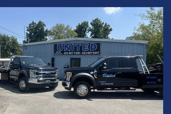 Front of United Wrecker & Transport with flatbed and tow truck
