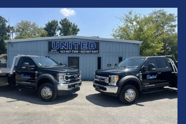 Front of United Wrecker & Transport with a flatbed and tow truck