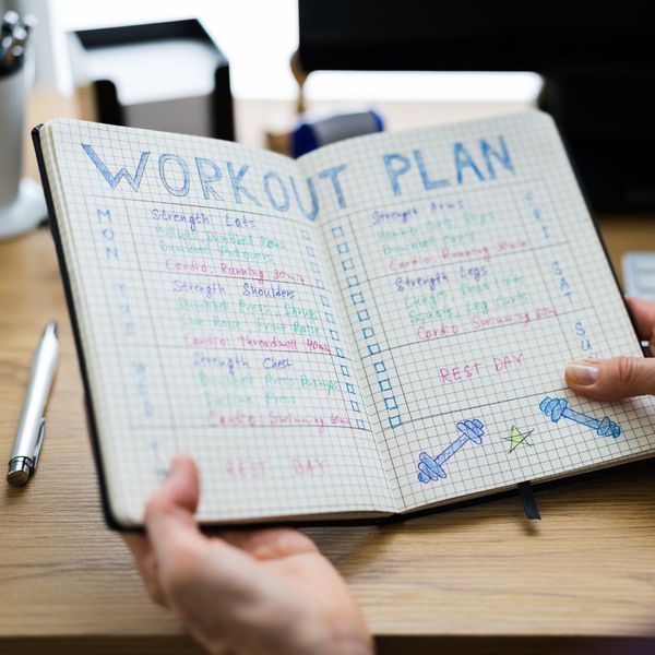 Notebook with a workout plan written in it. 