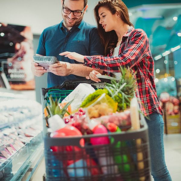 A couple looking at meat at the grocery store