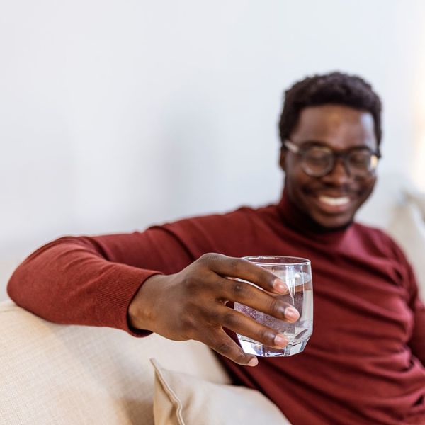 Young man with a glass of water