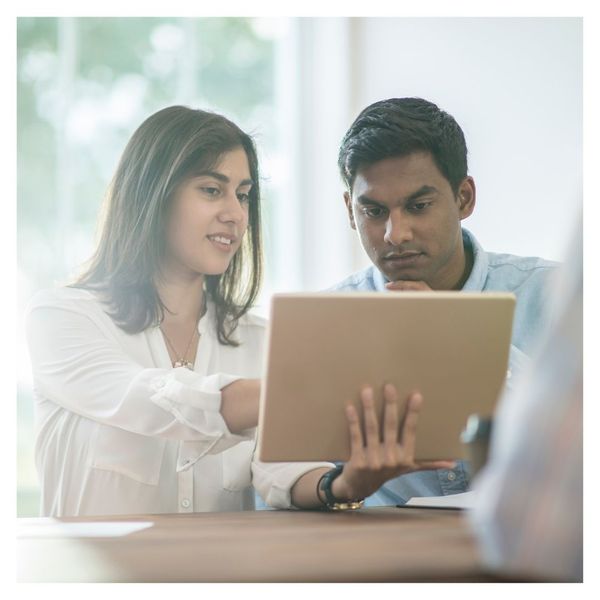 man and woman looking at tablet