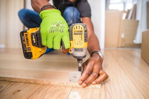 using drill to put together wood furniture