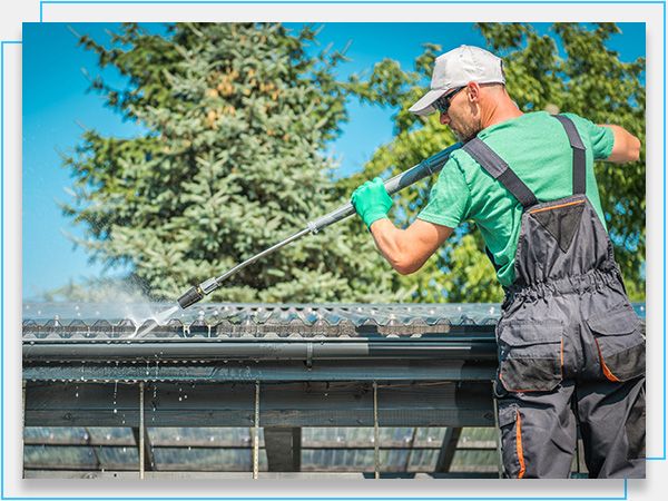 technician spraying gutter