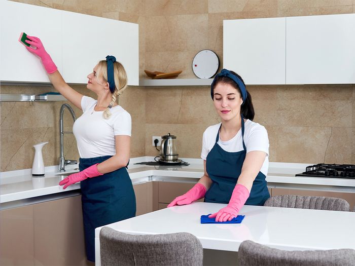 2 girls cleaning kitchen