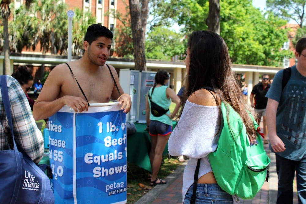 Image of Manny Rutinell shirtless wearing a PETA shower curtian - The Independent Florida Alligator.jpeg