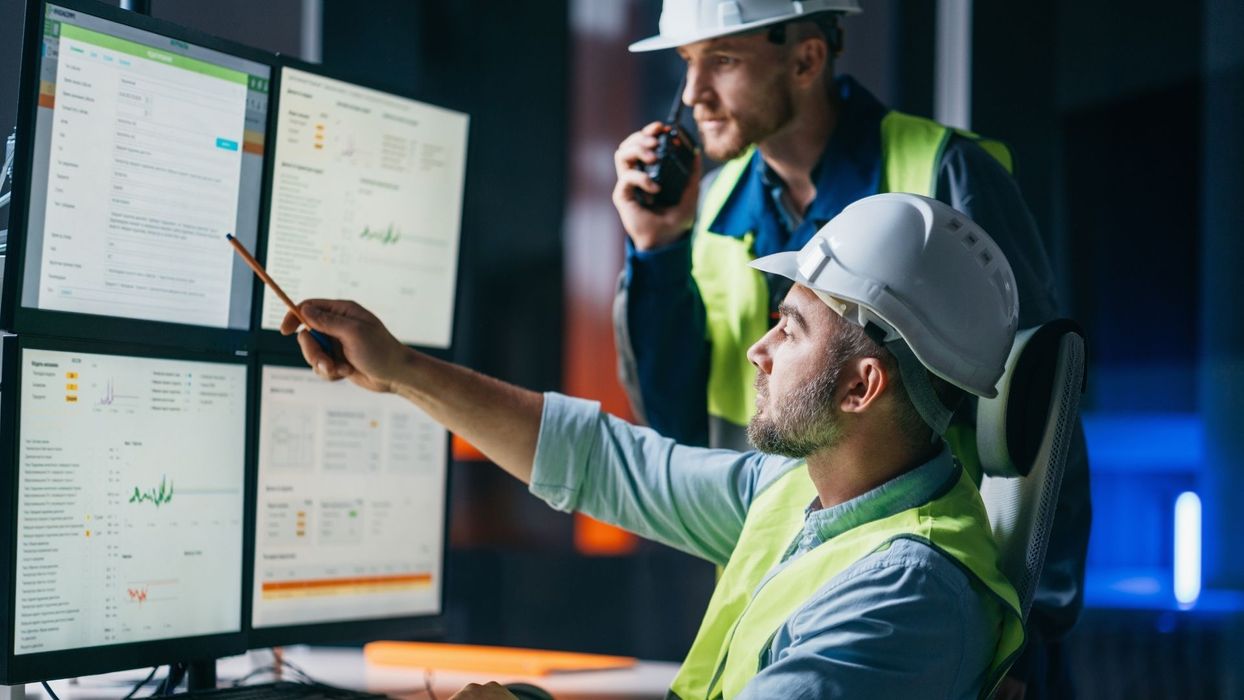 two technicians looking at data via their SCADA system