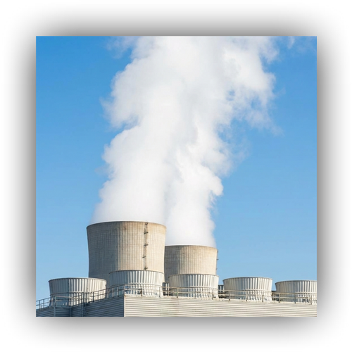 Large cooling towers at a petrochemical facility releasing clean steam.