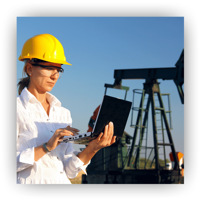 oil worker in field on computer