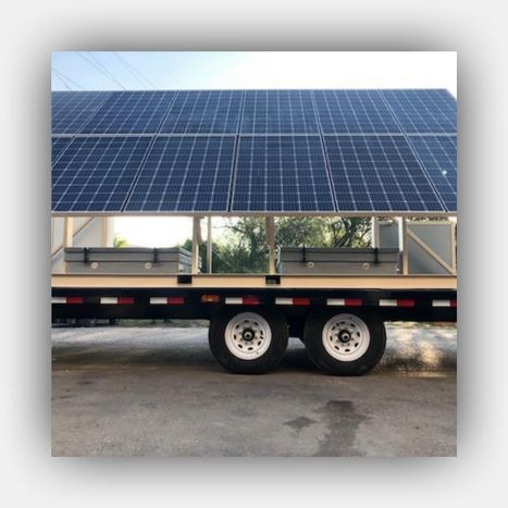 An engineer inspecting a durable, weather-resistant enclosure housing G&C's solar and UPS control components.
