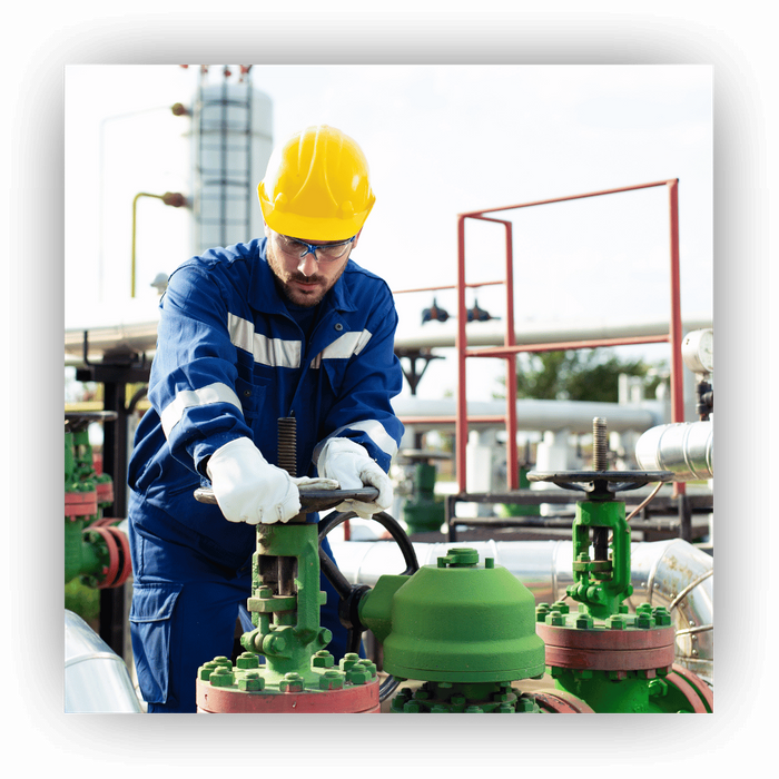 oil and gas worker turning valve