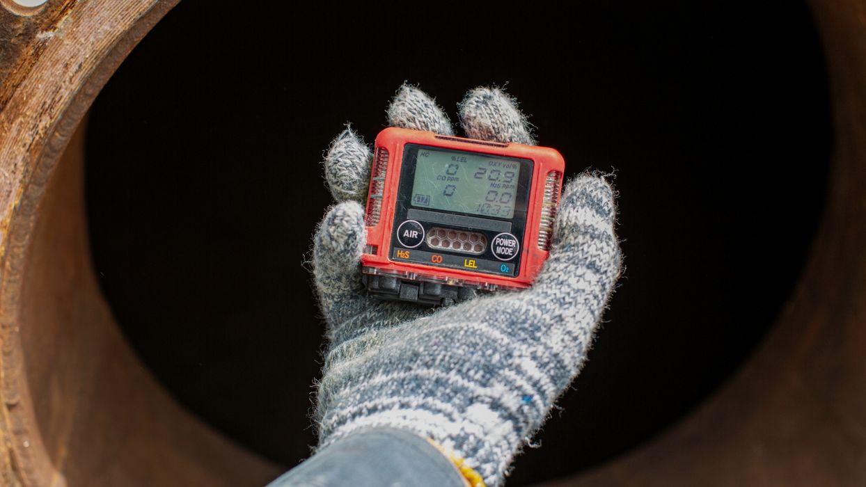 Hand holding a meter for oil and gas measurement