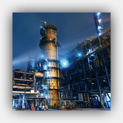A G&C consultant in a hard hat and safety vest, using a tablet to document findings near industrial equipment, emphasizing a professional on-site assessment.