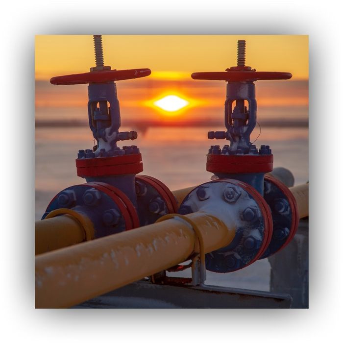 Sun setting on an oil and gas operation