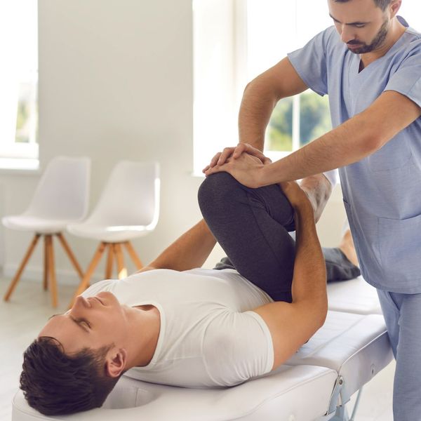 male chiropractor working with patient