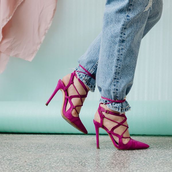 woman in pink high heels and jeans