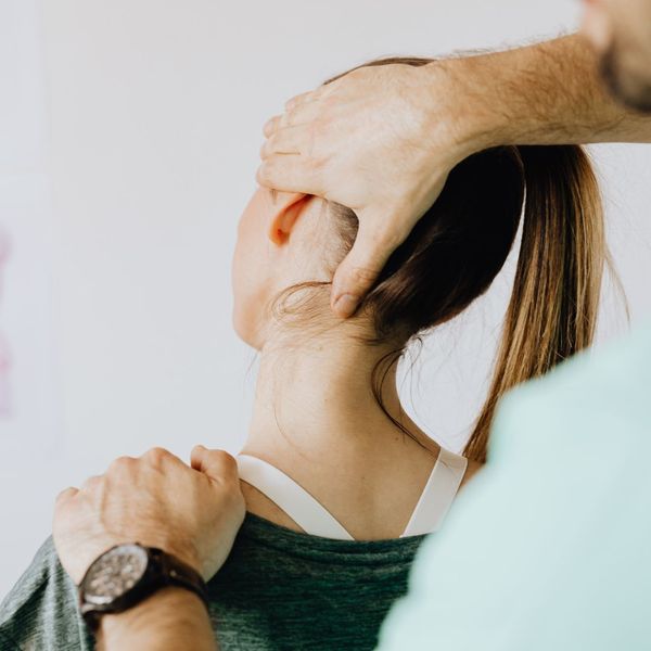 chiropractor stretching womans neck