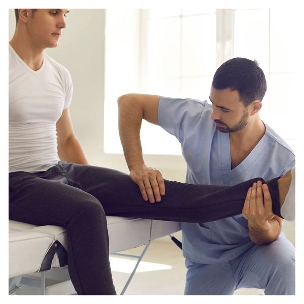 chiropractor working on patient's leg