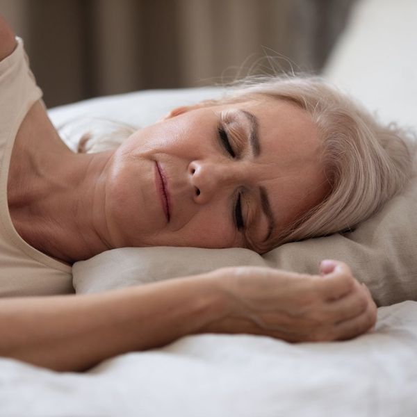 older woman laying on bed sleeping