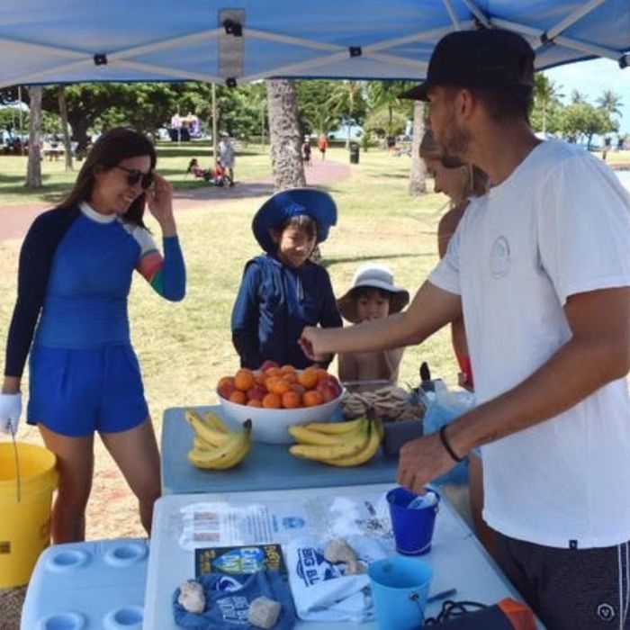 woman and kids visiting stand