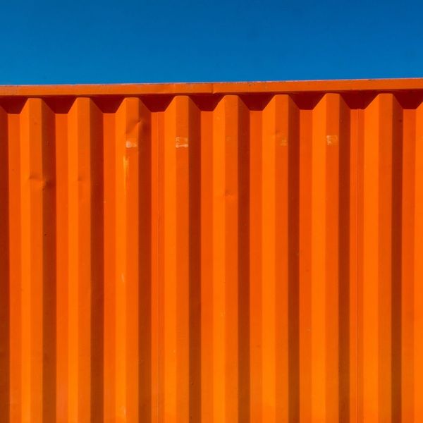 bright orange container against deep blue sky