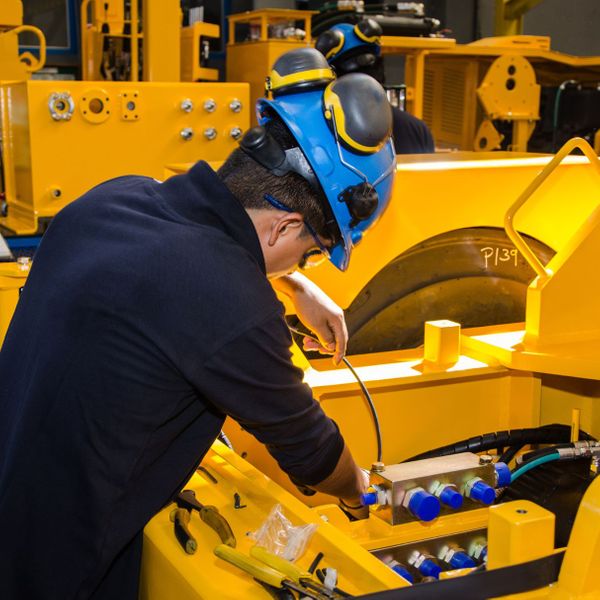 man repairing heavy machinery