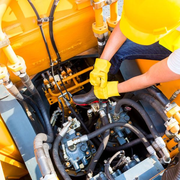 man fixing construction equipment