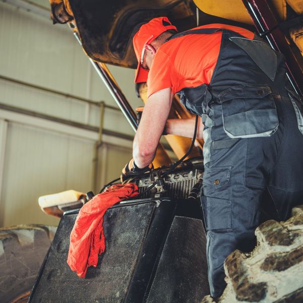 man fixing heavy machinery