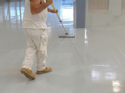 Epoxy coating being applied to floors