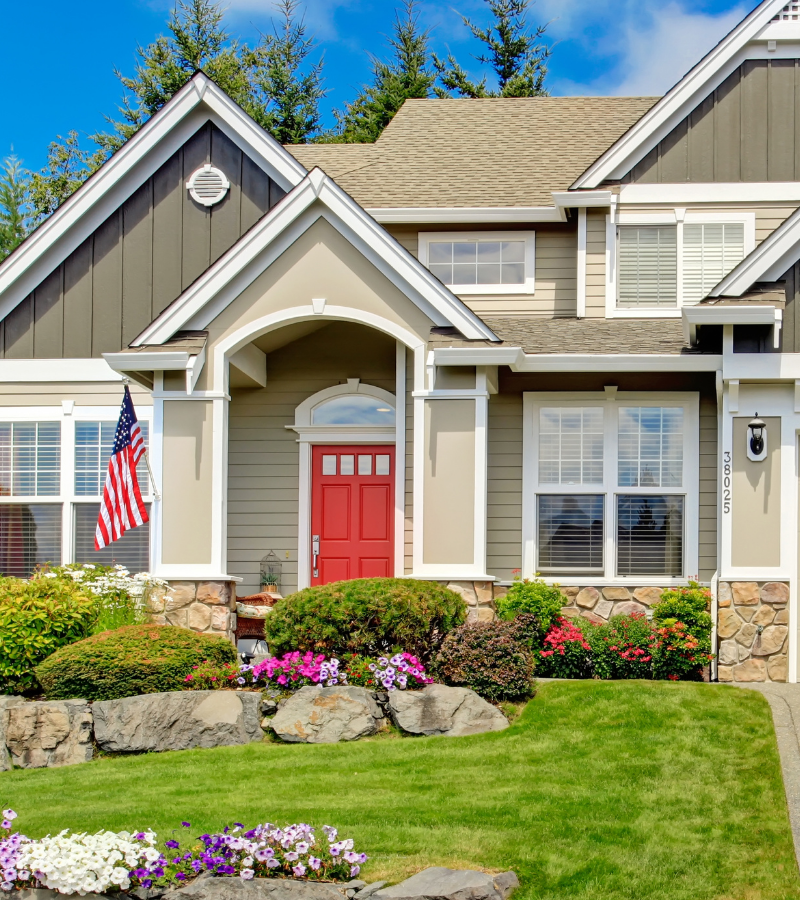 A large home with a red front door