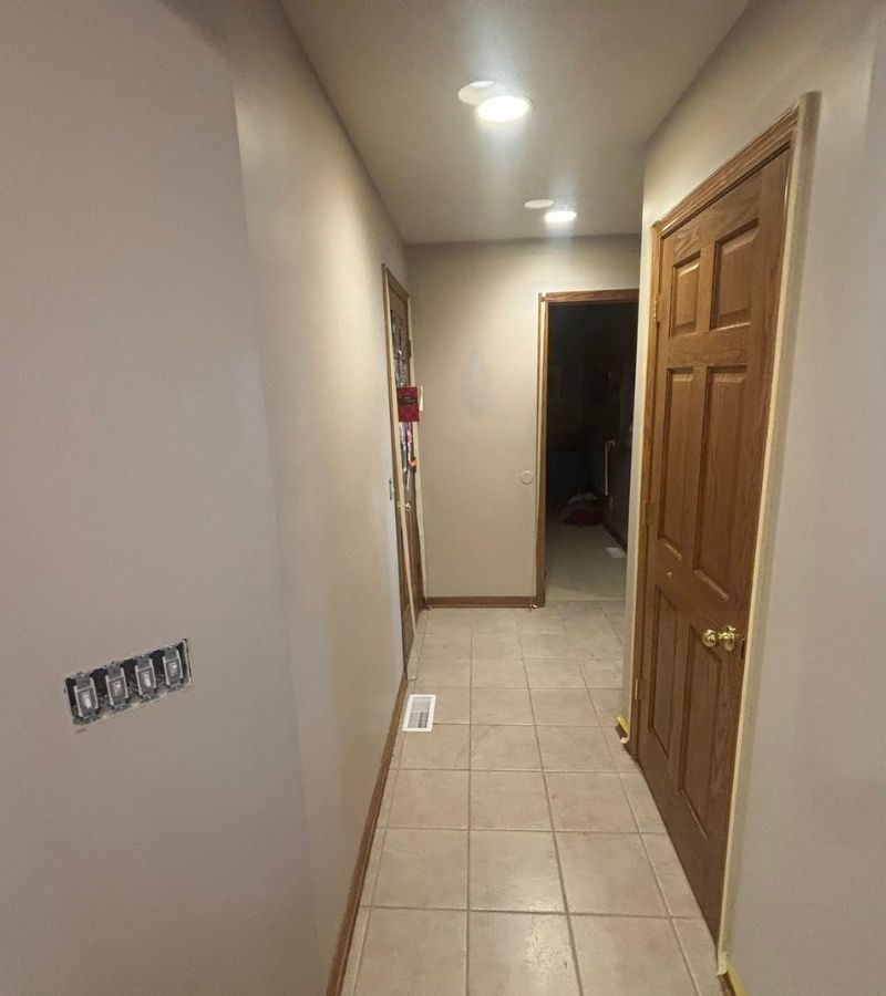 A hallway painted a dark tan color