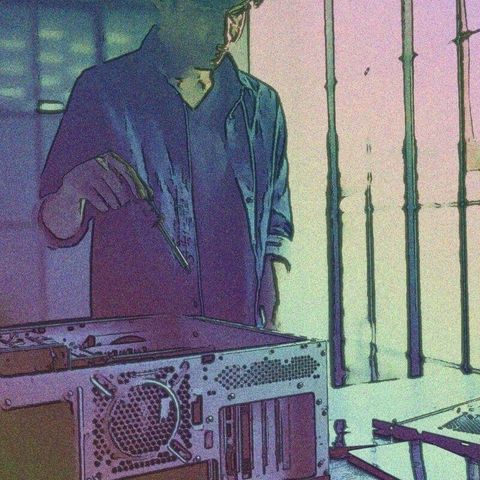 man using tools on computer hardware