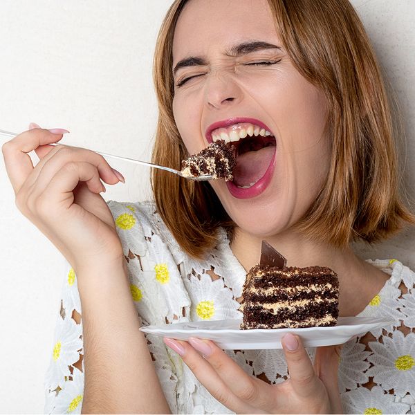 Happy woman eating cake