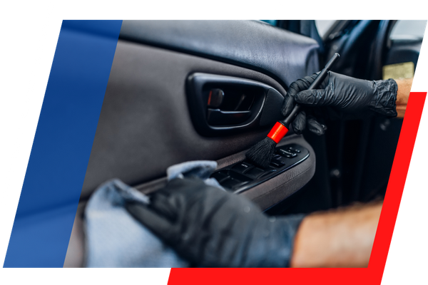 cleaning a door inside a car with a brush