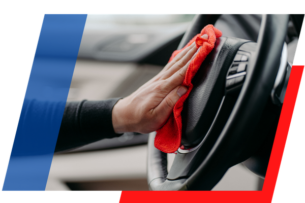 cleaning a steering wheel with a red cloth