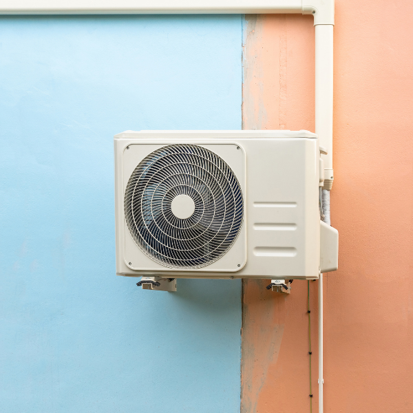 heat pump on bright blue and orange wall