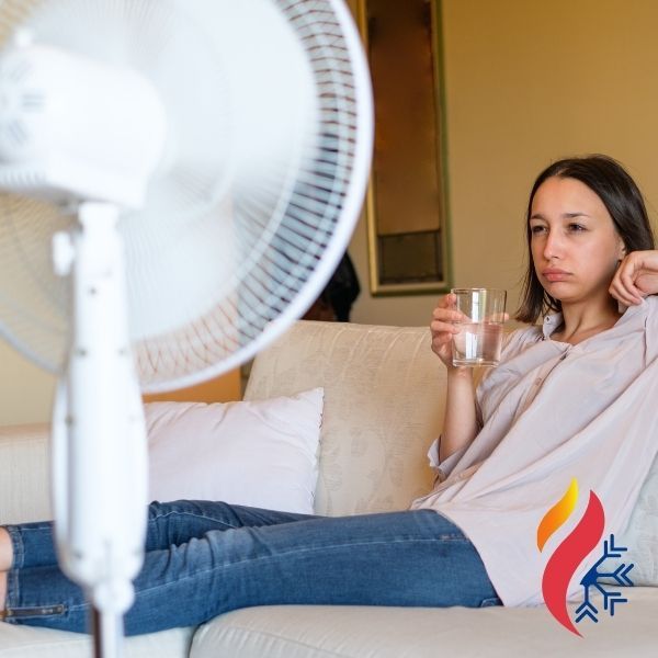 woman sitting in front of fan