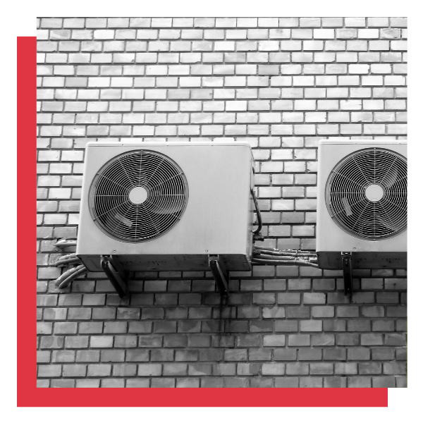 heat pump units on brick wall