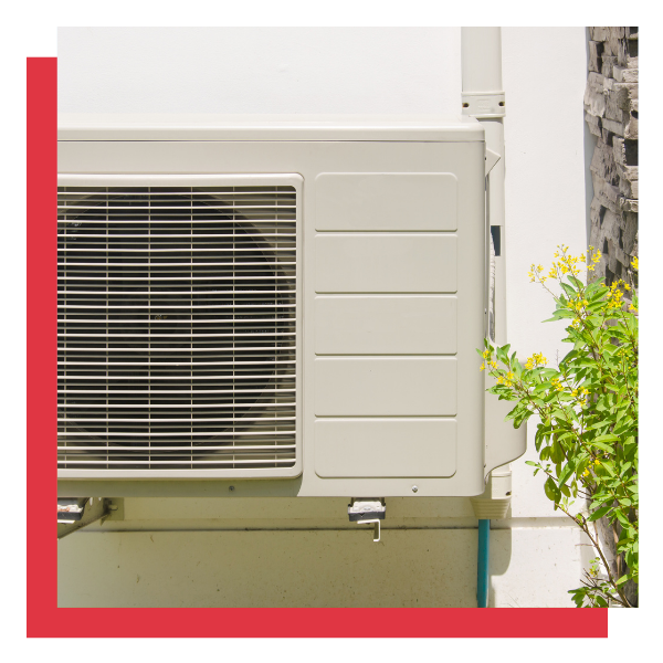 simple heat pump unit on wall of house