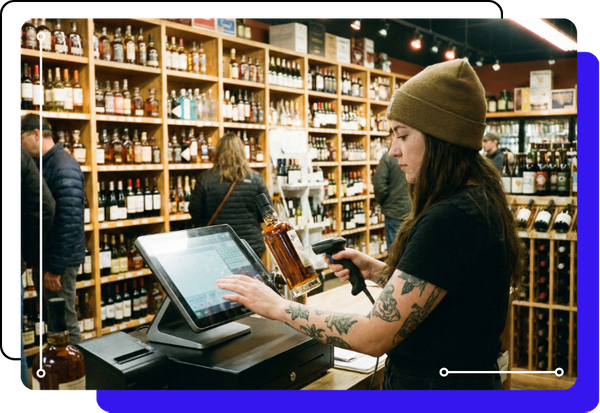 a liquor store cashier scanning bottles with a POS system