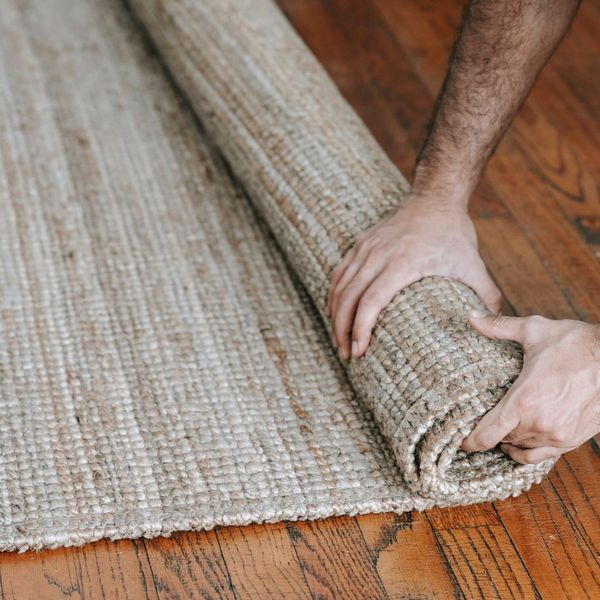 person putting a rug out person putting a rug out