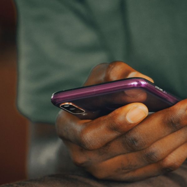 person using a phone to report a rent payment