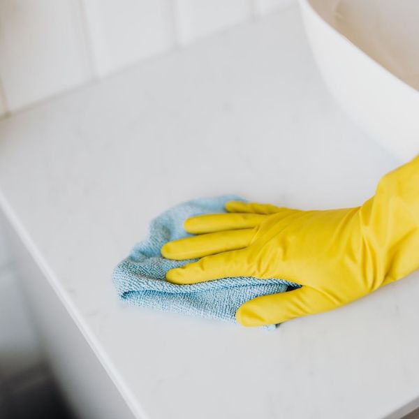 hand wiping off a bathroom counter