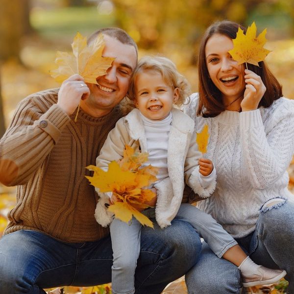 family holding fall leaves family holding fall leaves
